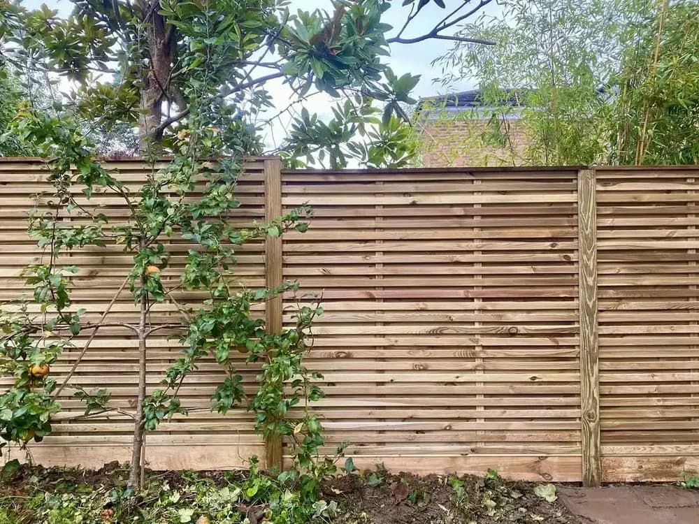 A completed panel fence in a Kent garden, built on site by Fencecraft A completed panel fence in a Kent garden, built on site by Fencecraft