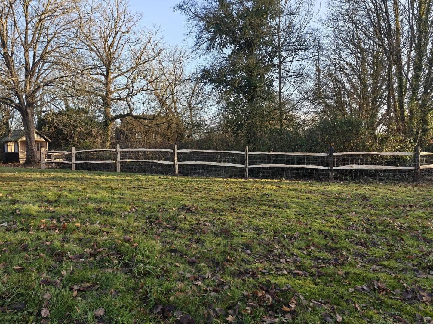 Post and rail fencing with stock wire around a paddock, built by Fencecraft Post and rail fencing with stock wire around a paddock, built by Fencecraft